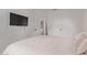 The bright bedroom includes neutral walls, carpet flooring and a wall-mounted TV at 3466 E Bruce Ave, Gilbert, AZ 85234