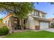 Lovely two-story home featuring a lush green lawn, a two-car garage, and covered porch at 3466 E Bruce Ave, Gilbert, AZ 85234