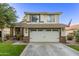 Welcoming two-story home showcasing a two-car garage, manicured lawn, and classic design at 3466 E Bruce Ave, Gilbert, AZ 85234