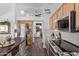 Spacious kitchen with stainless steel appliances, tile backsplash, and view into the living area at 3466 E Bruce Ave, Gilbert, AZ 85234