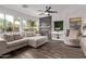 Open concept living room with fireplace, large windows, and hardwood floors at 3466 E Bruce Ave, Gilbert, AZ 85234