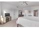 Well-lit main bedroom features a dresser, an electric fireplace, and neutral carpeting at 3466 E Bruce Ave, Gilbert, AZ 85234