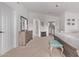 Spacious bedroom featuring an ensuite bathroom, light walls, and a comfortable sitting bench at 3466 E Bruce Ave, Gilbert, AZ 85234