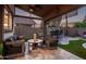 Enjoy this covered patio with pavers, ample seating, and an outdoor kitchen at 3466 E Bruce Ave, Gilbert, AZ 85234