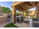 Inviting covered patio features comfortable seating and a built-in bar, perfect for outdoor entertaining at 3466 E Bruce Ave, Gilbert, AZ 85234