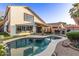 Stunning backyard showcasing a refreshing pool, artificial turf, outdoor kitchen, and covered patio at 3466 E Bruce Ave, Gilbert, AZ 85234