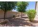 This backyard features gravel and desert landscaping along a block wall for privacy at 3507 E Alfalfa Dr, Gilbert, AZ 85298