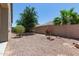 Low maintenance backyard with decorative rock landscaping, trees, and shrubbery at 3507 E Alfalfa Dr, Gilbert, AZ 85298
