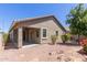 A covered patio complements this home's backyard with low maintenance landscaping and a neutral exterior at 3507 E Alfalfa Dr, Gilbert, AZ 85298