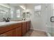 Bathroom features a double sink vanity with granite countertop and decorative mirrors at 3507 E Alfalfa Dr, Gilbert, AZ 85298