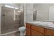 Bathroom features a stand-up shower, neutral tile, and a sink with wooden cabinets at 3507 E Alfalfa Dr, Gilbert, AZ 85298