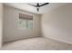 Cozy bedroom with neutral carpet, a ceiling fan, and a sunny window at 3507 E Alfalfa Dr, Gilbert, AZ 85298