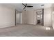Spacious carpeted bedroom offers a neutral color palette and access to the bathroom at 3507 E Alfalfa Dr, Gilbert, AZ 85298