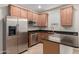 Beautiful kitchen with stainless steel appliances, granite countertops, and stylish wood cabinets at 3507 E Alfalfa Dr, Gilbert, AZ 85298