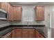 Bright kitchen featuring a stainless steel sink, granite countertops, and light wood cabinets at 3507 E Alfalfa Dr, Gilbert, AZ 85298