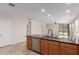 Open kitchen with stainless appliances, wood cabinetry, and a breakfast bar overlooking the living area and backyard at 3507 E Alfalfa Dr, Gilbert, AZ 85298