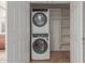 Convenient laundry closet with stacked washer and dryer, plus storage shelves at 3507 E Alfalfa Dr, Gilbert, AZ 85298