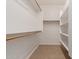 Walk-in closet with carpeted flooring and ample shelving and hanging storage at 3507 E Alfalfa Dr, Gilbert, AZ 85298