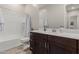 Bright bathroom featuring a shower-tub combo and modern, dark wood vanity at 3852 E Bartlett Way, Chandler, AZ 85249
