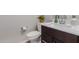 Clean and modern half-bathroom with a white countertop and dark wood vanity at 3852 E Bartlett Way, Chandler, AZ 85249