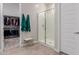 Bright bathroom featuring a glass shower, tile floors, and adjacent walk-in closet at 3852 E Bartlett Way, Chandler, AZ 85249