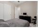 Stylish bedroom with dark wood furniture, modern decor, and ample natural light at 3852 E Bartlett Way, Chandler, AZ 85249