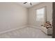 Neutral bedroom with a plush recliner, soft carpeting, and plenty of natural light at 3852 E Bartlett Way, Chandler, AZ 85249
