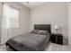 Cozy bedroom with a plush bed, window with blinds, and a bedside table at 3852 E Bartlett Way, Chandler, AZ 85249