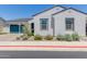 Charming single-story home featuring a blue garage door and decorative tile accents around the windows at 3852 E Bartlett Way, Chandler, AZ 85249