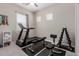 Bright home gym with a treadmill, weight bench, and various weight sets at 3852 E Bartlett Way, Chandler, AZ 85249