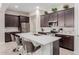 Spacious kitchen featuring an island with bar seating and dark cabinets at 3852 E Bartlett Way, Chandler, AZ 85249