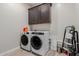 Well-lit laundry room featuring a front load washer and dryer at 3852 E Bartlett Way, Chandler, AZ 85249
