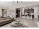 Open-concept living room and kitchen with a comfortable couch and modern bar stools at 3852 E Bartlett Way, Chandler, AZ 85249