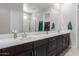 Elegant bathroom featuring double sinks, a large mirror, and plenty of counter space at 3852 E Bartlett Way, Chandler, AZ 85249