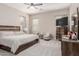 Bright main bedroom boasts a ceiling fan and ample space for relaxation and entertainment at 3852 E Bartlett Way, Chandler, AZ 85249