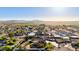 Scenic aerial shot of a rural neighborhood with distant mountains and an agricultural field in the background at 3927 E Vista Grande --, San Tan Valley, AZ 85140