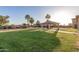Spacious backyard with lush lawn, a covered patio, and mature trees, perfect for outdoor activities and relaxation at 3927 E Vista Grande --, San Tan Valley, AZ 85140