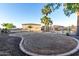 Expansive backyard with palm trees, a pool with black wrought iron fencing, and rock landscaping at 3927 E Vista Grande --, San Tan Valley, AZ 85140