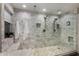 This renovated bathroom features a glass-enclosed marble tiled shower with a built-in bench and dual shower heads at 3927 E Vista Grande --, San Tan Valley, AZ 85140