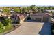 Expansive home with a spacious driveway and multi-car garage, showcasing desert landscaping and neutral color palette at 3927 E Vista Grande --, San Tan Valley, AZ 85140