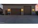 Detached three-car garage featuring a tile roof and coach lights at dusk at 3927 E Vista Grande --, San Tan Valley, AZ 85140