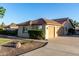 Attached three-car garage featuring a tile roof and a concrete driveway with desert landscaping at 3927 E Vista Grande --, San Tan Valley, AZ 85140