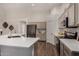 A sleek kitchen with a large island, stainless steel appliances, and wood-look tile flooring at 3927 E Vista Grande --, San Tan Valley, AZ 85140