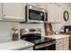 Modern kitchen with stainless appliances, quartz countertops, and gray cabinets at 3927 E Vista Grande --, San Tan Valley, AZ 85140