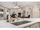 Modern kitchen with a large island, stainless steel sink, and open view to the living room at 3927 E Vista Grande --, San Tan Valley, AZ 85140