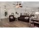 Open living room with tiled floors, fireplace, chandeliers, and comfortable reclining sofa and armchairs at 3927 E Vista Grande --, San Tan Valley, AZ 85140
