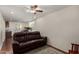Comfortable living room with wood floors, ceiling fan and reclining sofa at 3927 E Vista Grande --, San Tan Valley, AZ 85140
