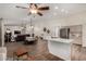 Open-concept living space boasts wood-look tile floors, stainless steel appliances, and a modern white countertop at 3927 E Vista Grande --, San Tan Valley, AZ 85140