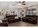 Spacious living room featuring leather sofas, decorative accessories, and wood-look tile flooring throughout at 3927 E Vista Grande --, San Tan Valley, AZ 85140