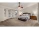 Spacious primary bedroom features large windows, fan and plush carpet at 3927 E Vista Grande --, San Tan Valley, AZ 85140